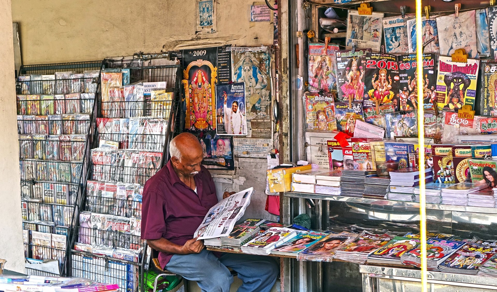 Old man at Singapore magazine stand